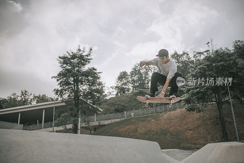 Asian skateboarder in action mid air x games